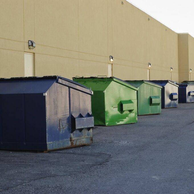garbage dumpsters near the wall